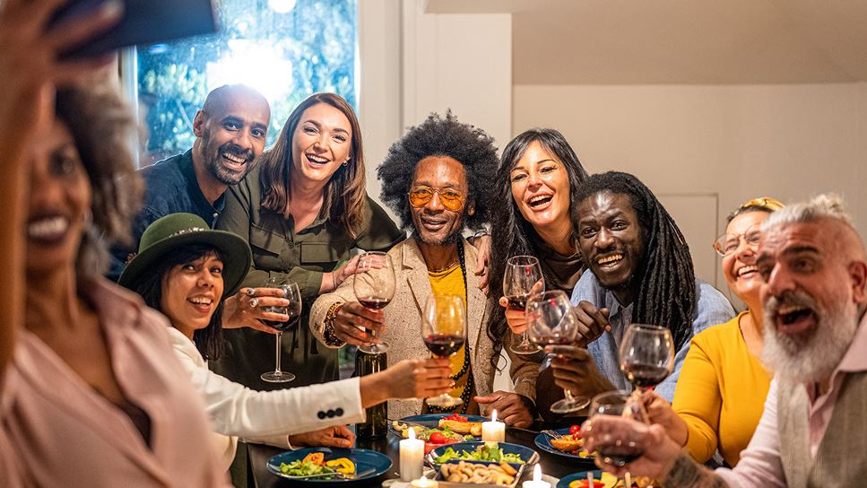 friends and family taking a selfie at a holiday dinner table