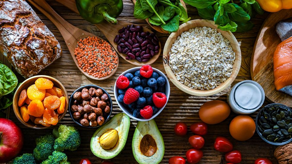 Foods fitting the MIND Diet eating pattern, including salmon, berries, leafy green vegetables, beans, nuts, seeds and oats