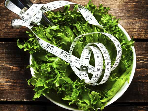 bowl of lettuce and measuring tape - Staying Away from Fad Diets