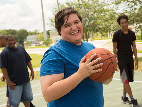 Men playing basketball at park
