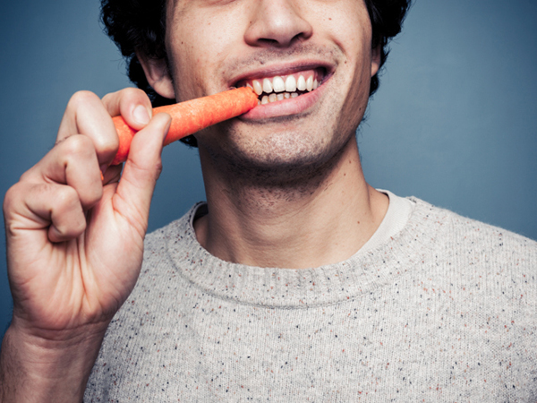 Man eating carrot - Eating Disorders: Problem also Affects Boys and Men