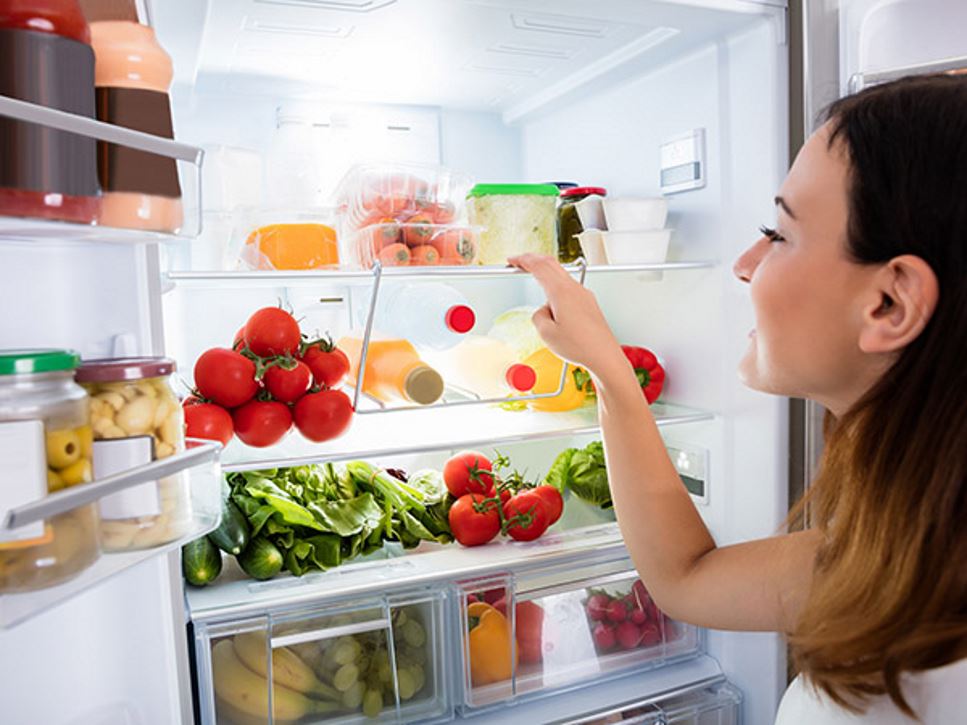 Woman looking in fridge