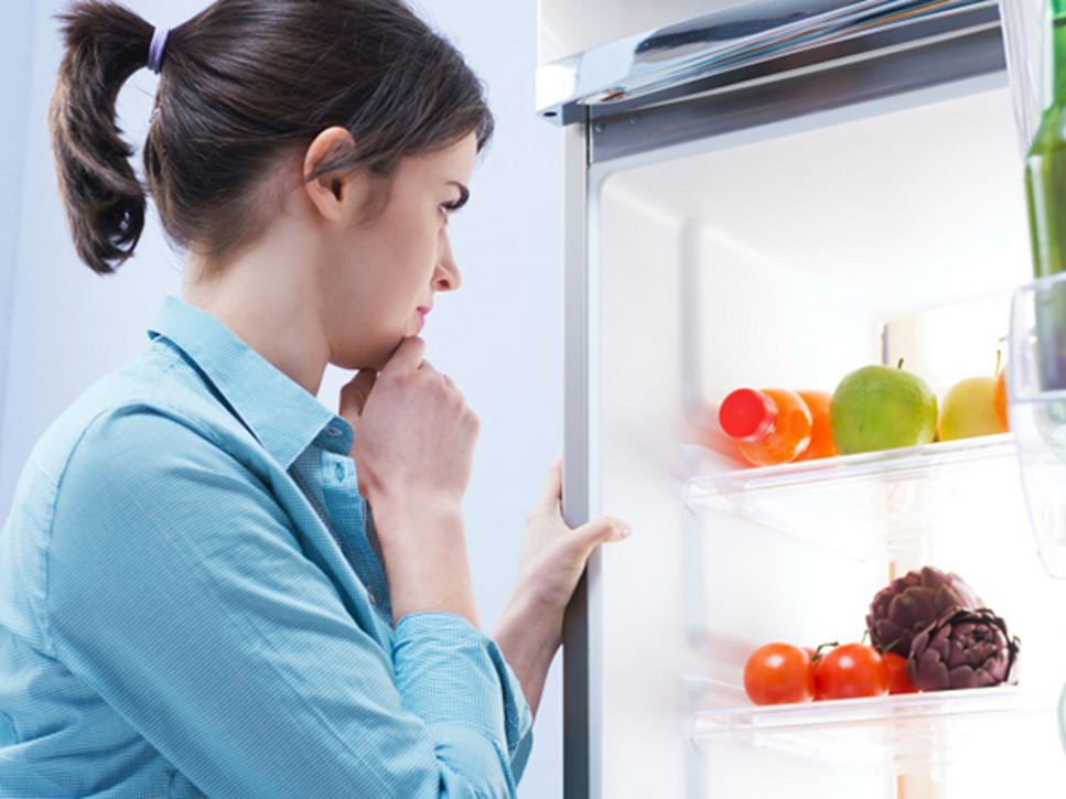 Woman with open refrigerator - What Is the Low FODMAP Diet?
