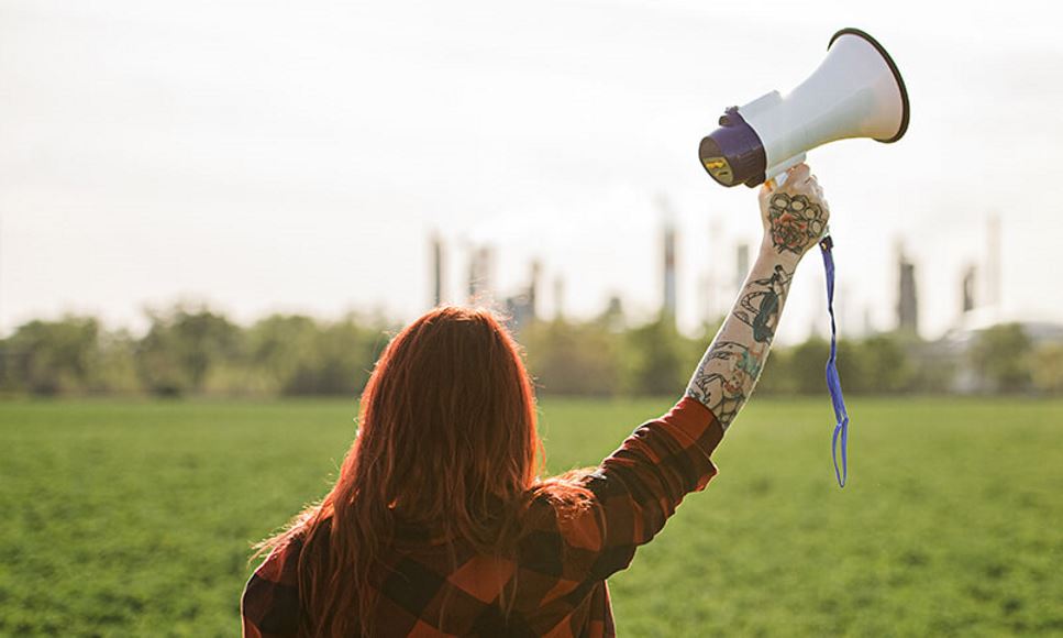 woman with megaphone standing outside