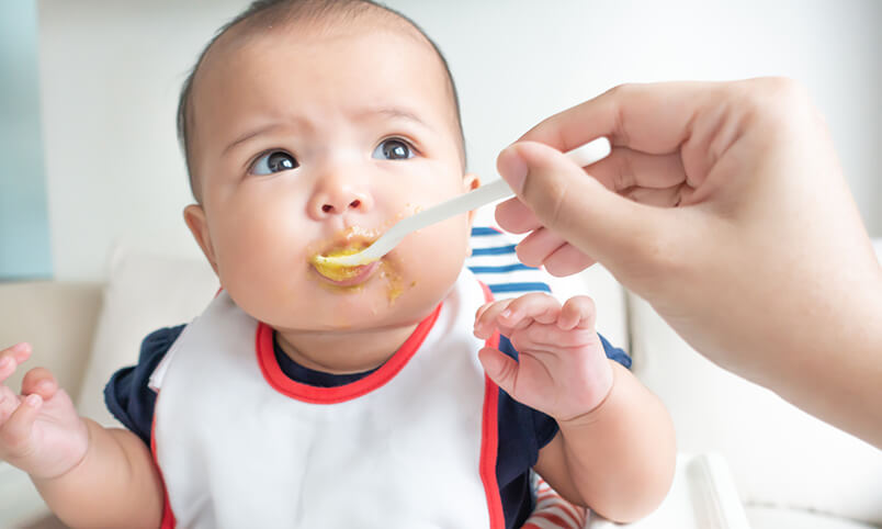 baby eating pureed food first food