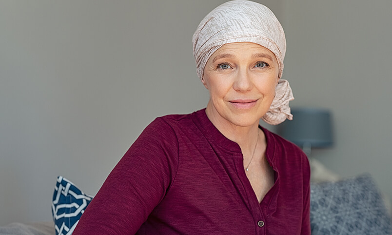 woman in head scarf with cancer