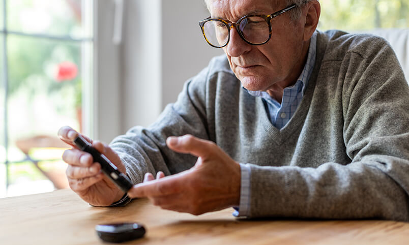 man testing blood sugar level with diabetes glucometer