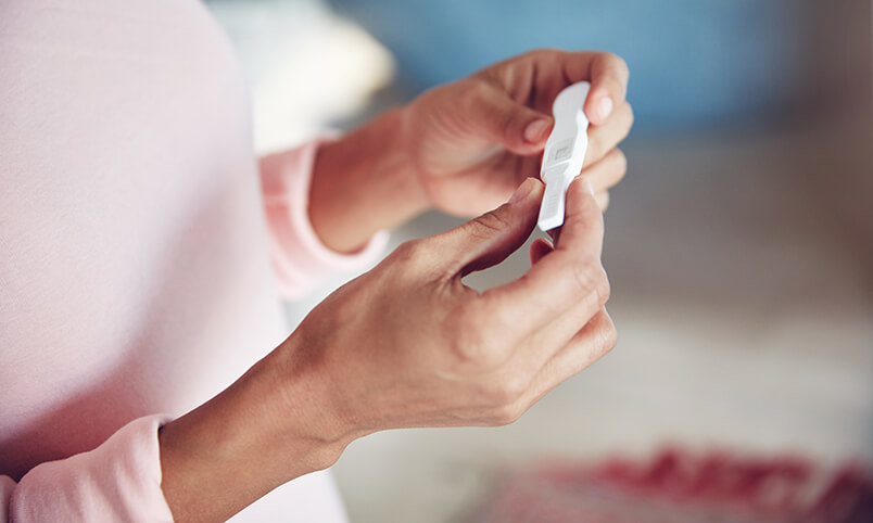 woman holding pregnancy test