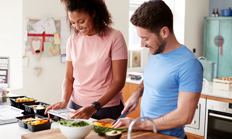 couple meal prep in kitchen