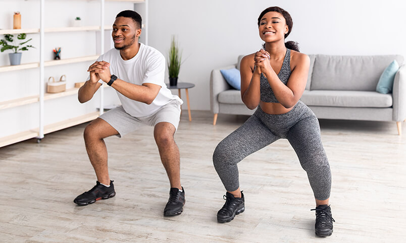 african american couple working out at home together