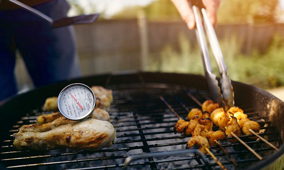 cooking on grill using a food thermometer for safety