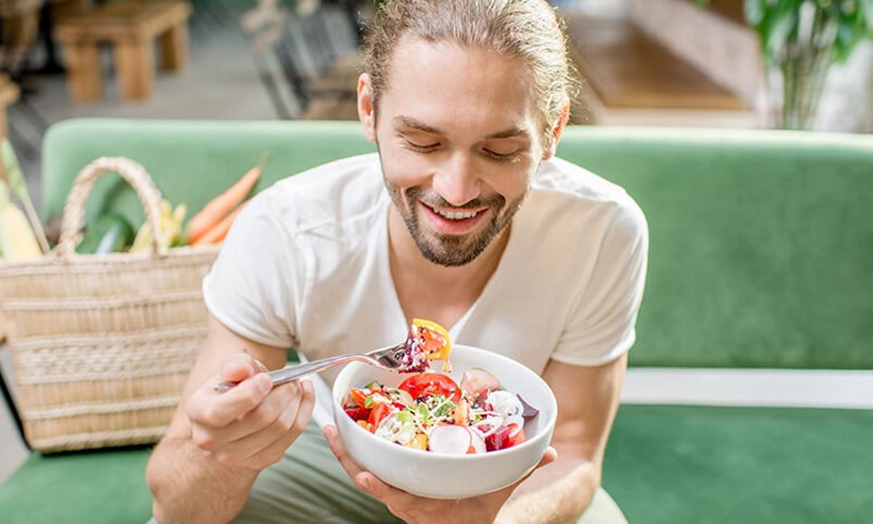 man eating plant-based vegetarian salad