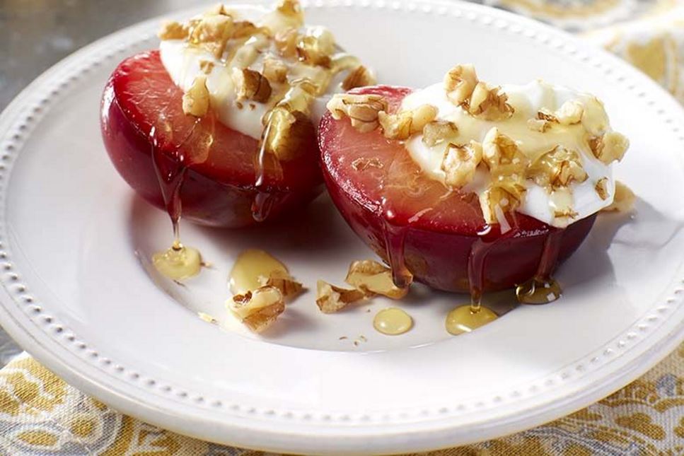 Plums topped with greek yogurt, walnuts and honey